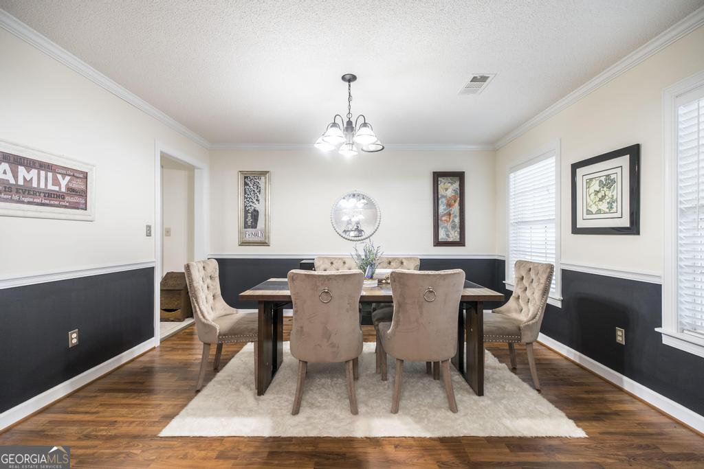 201 Strawberry Circle Dublin, GA 31021 - Photo 19 of 40 a view of a dining room with furniture and a chandelier