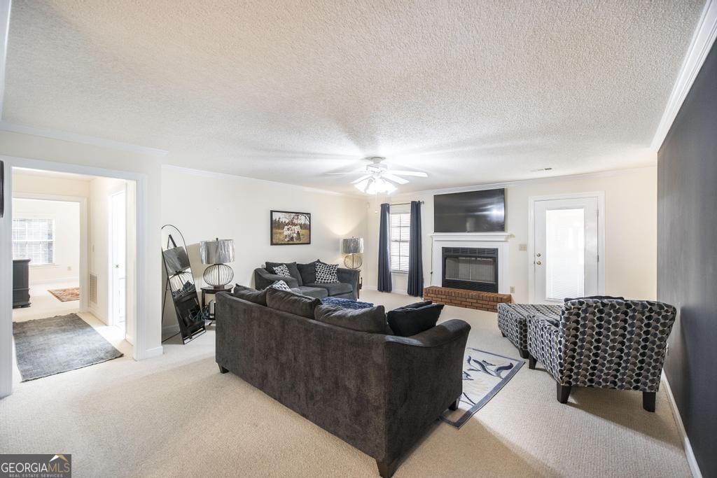 201 Strawberry Circle Dublin, GA 31021 - Photo 20 of 40 a living room with furniture fireplace and a flat screen tv