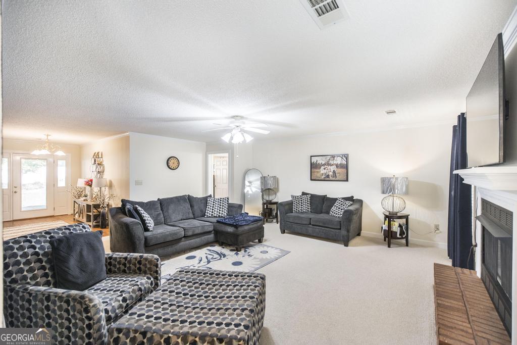 201 Strawberry Circle Dublin, GA 31021 - Photo 21 of 40 a living room with furniture or couch and a fireplace