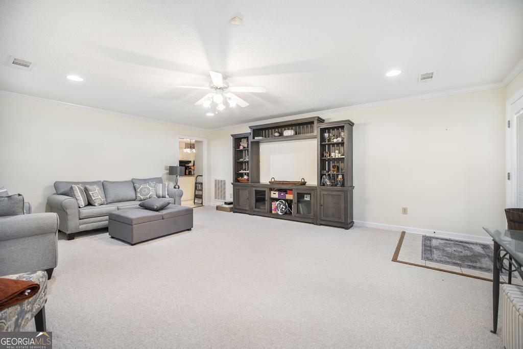 201 Strawberry Circle Dublin, GA 31021 - Photo 24 of 40 a living room with furniture and a flat screen tv