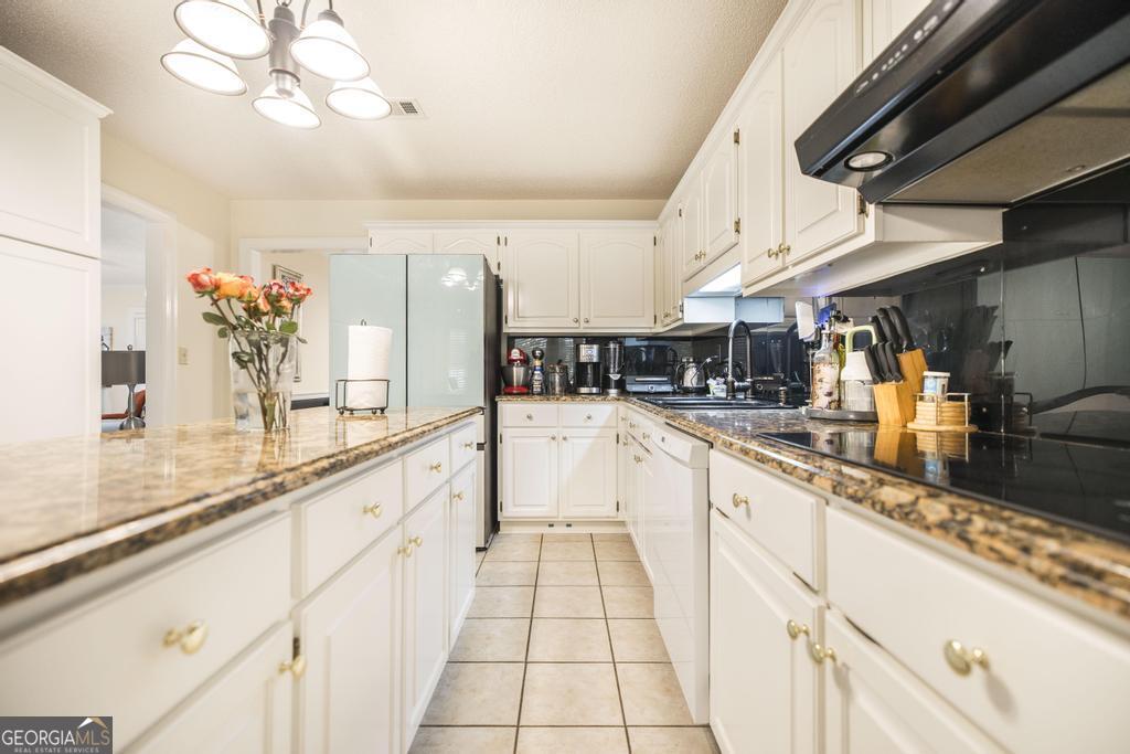 201 Strawberry Circle Dublin, GA 31021 - Photo 27 of 40 a large white kitchen with a large window