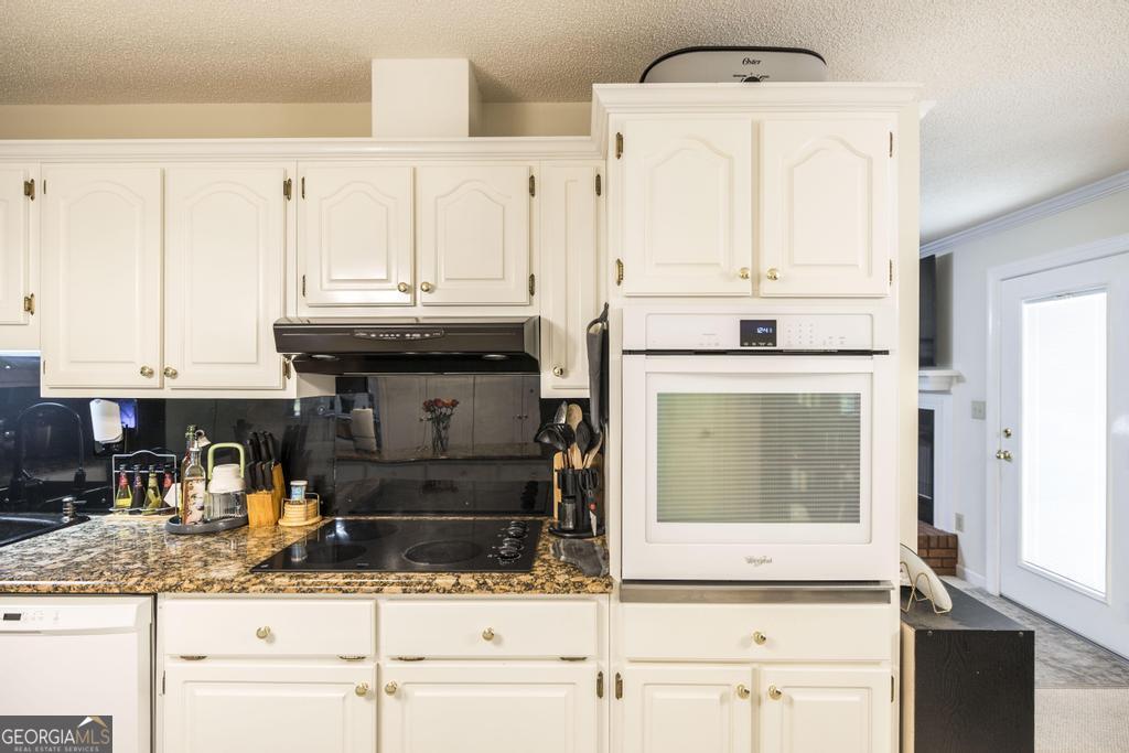 201 Strawberry Circle Dublin, GA 31021 - Photo 28 of 40 a kitchen with stainless steel appliances kitchen island granite countertop a refrigerator and cabinets