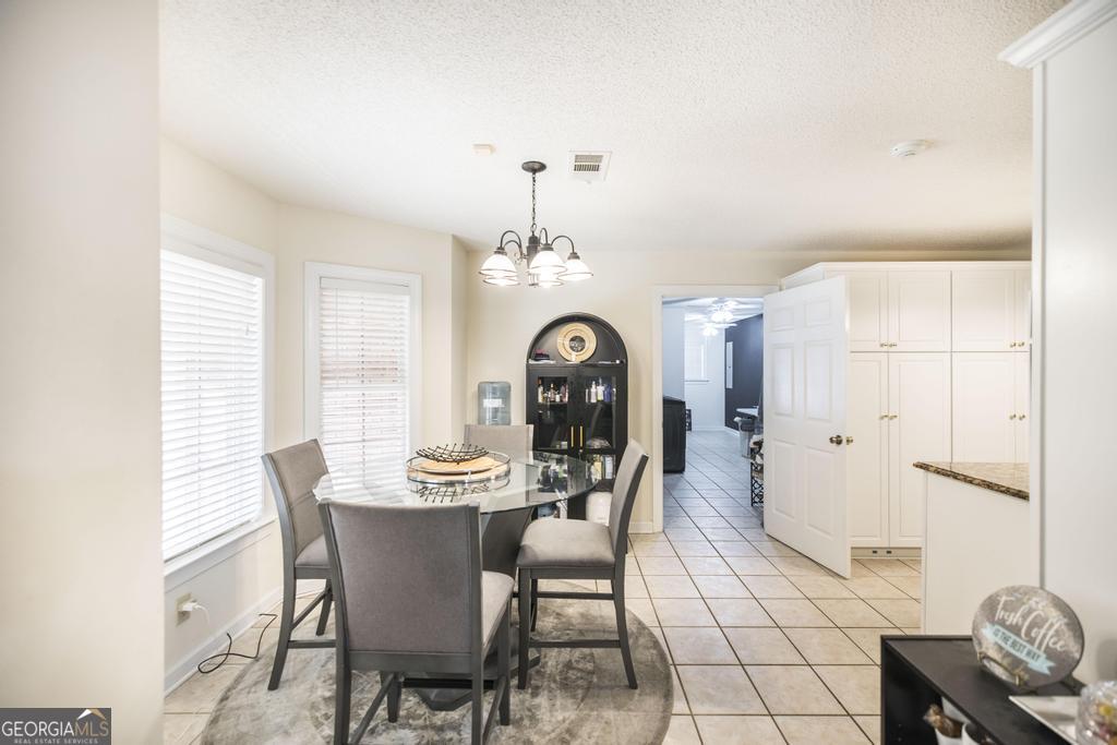 201 Strawberry Circle Dublin, GA 31021 - Photo 30 of 40 a view of a dining room with furniture and chandelier