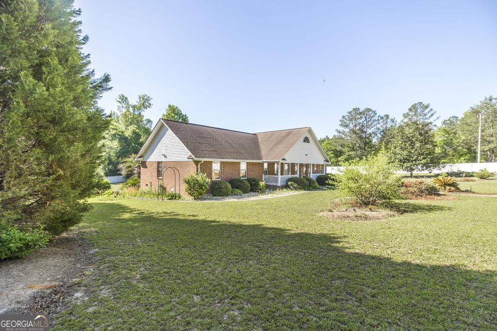 201 Strawberry Circle Dublin, GA 31021 - Photo 3 of 40 a front view of house with yard and lake
