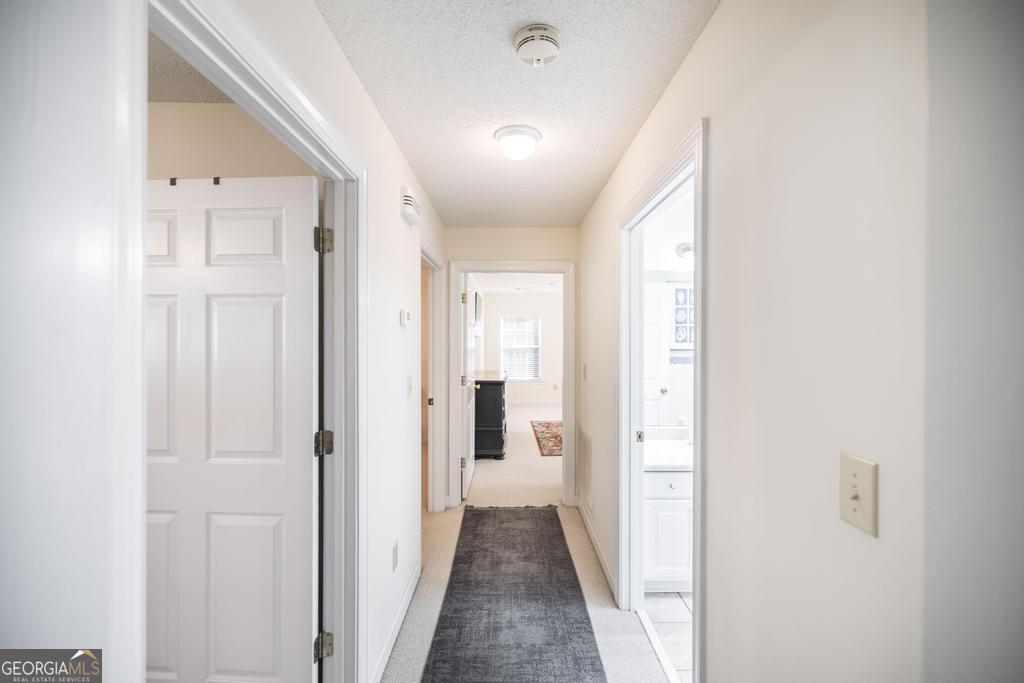 201 Strawberry Circle Dublin, GA 31021 - Photo 32 of 40 a view of a hallway with wooden shelves