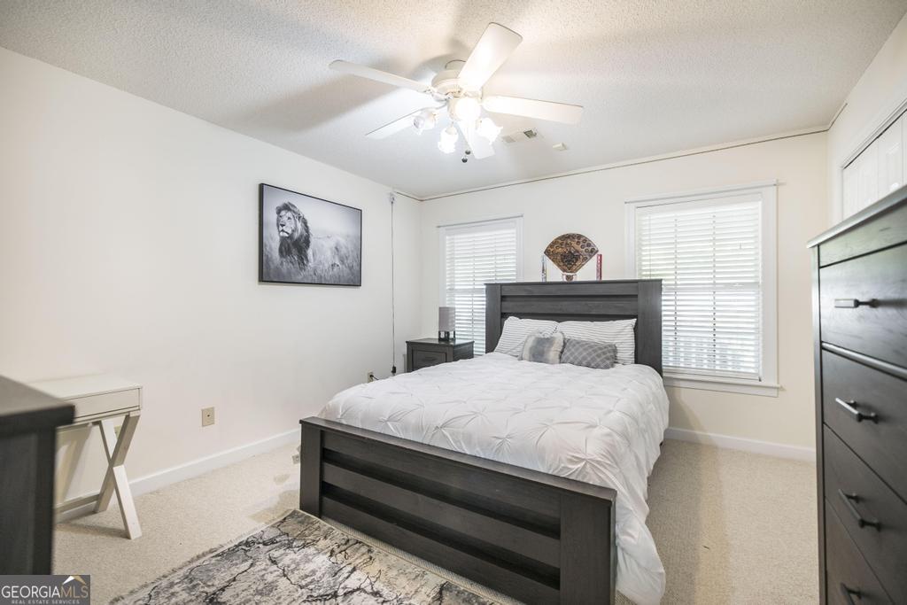 201 Strawberry Circle Dublin, GA 31021 - Photo 33 of 40 a bedroom with a bed and a chandelier