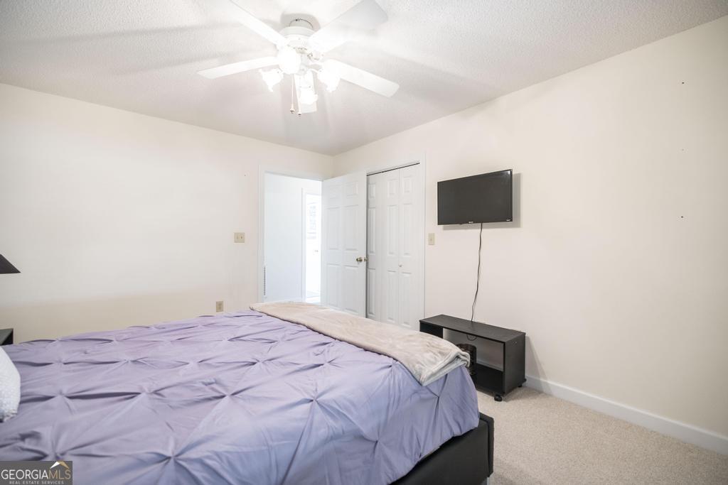 201 Strawberry Circle Dublin, GA 31021 - Photo 36 of 40 a bedroom with a bed and a chandelier