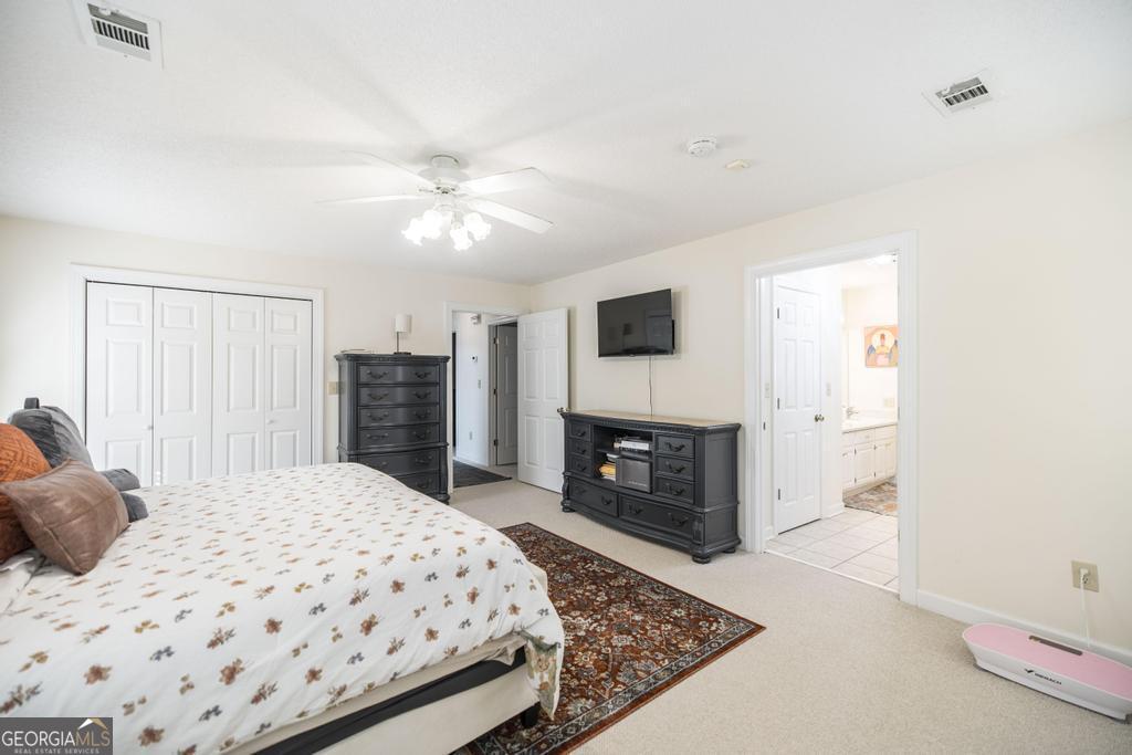 201 Strawberry Circle Dublin, GA 31021 - Photo 38 of 40 a bedroom with a bed and a fireplace