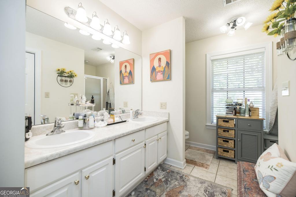201 Strawberry Circle Dublin, GA 31021 - Photo 39 of 40 a spacious bathroom with a double vanity sink mirror and
