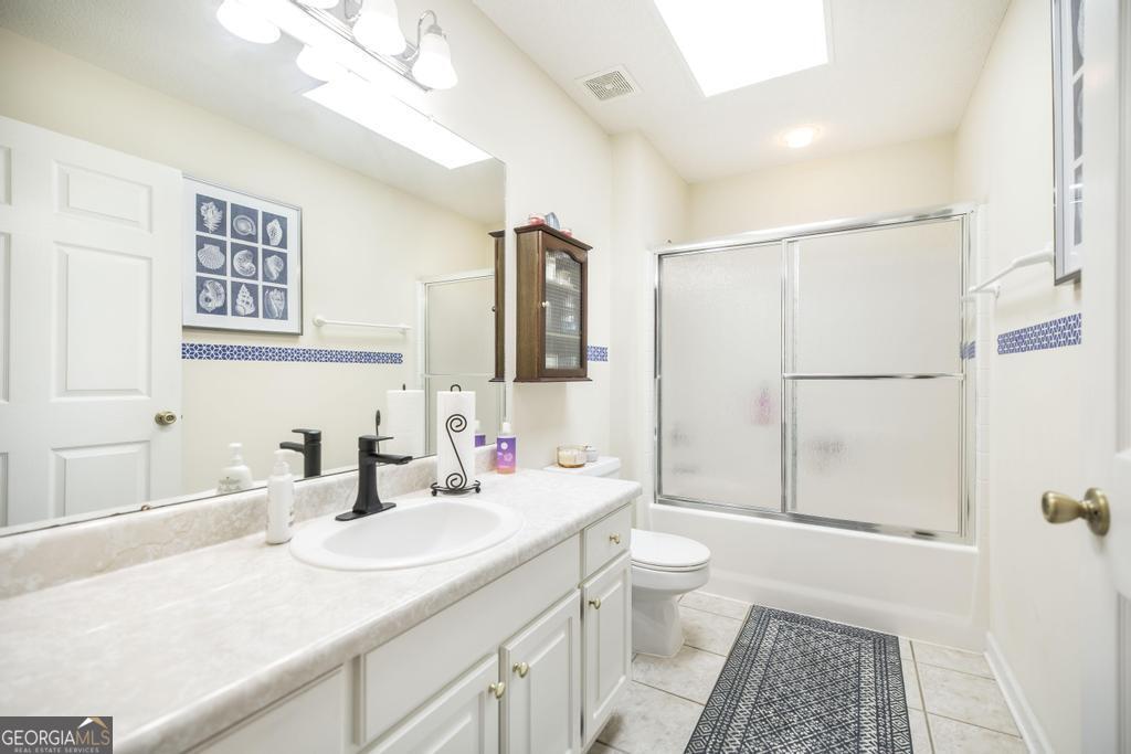 201 Strawberry Circle Dublin, GA 31021 - Photo 40 of 40 a bathroom with a sink a toilet and shower