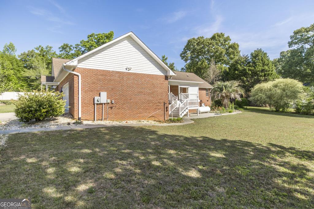 201 Strawberry Circle Dublin, GA 31021 - Photo 6 of 40 a front view of a house with a garden and yard