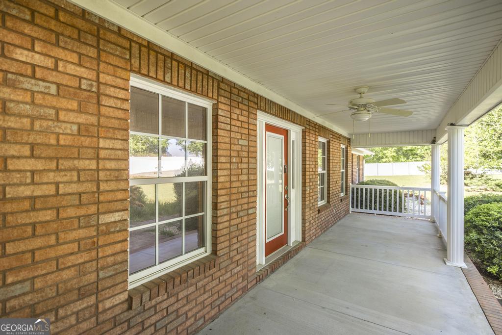 201 Strawberry Circle Dublin, GA 31021 - Photo 10 of 40 a view of a porch with wooden floor and fence