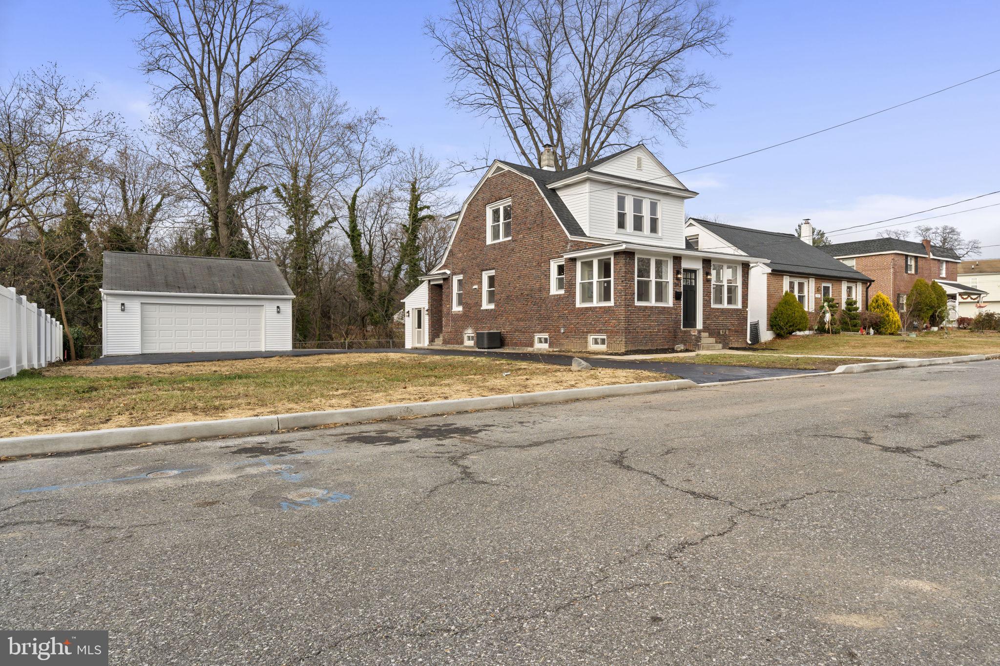 242 Willard Drive Ridley Park, PA 19078 - Photo 2 of 72 a front view of a house with a yard