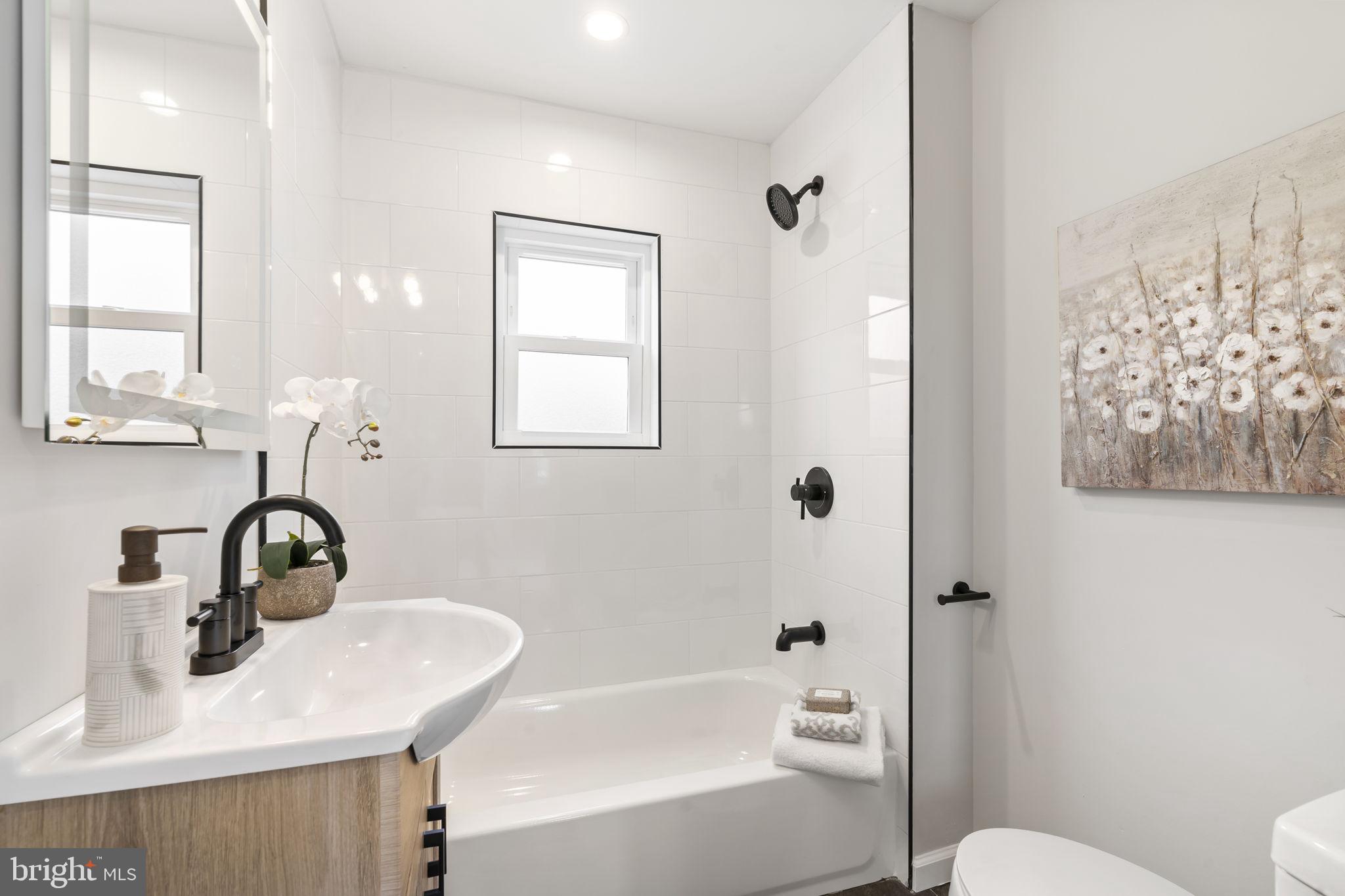 242 Willard Drive Ridley Park, PA 19078 - Photo 63 of 72 a bathroom with a sink mirror toilet and bathtub