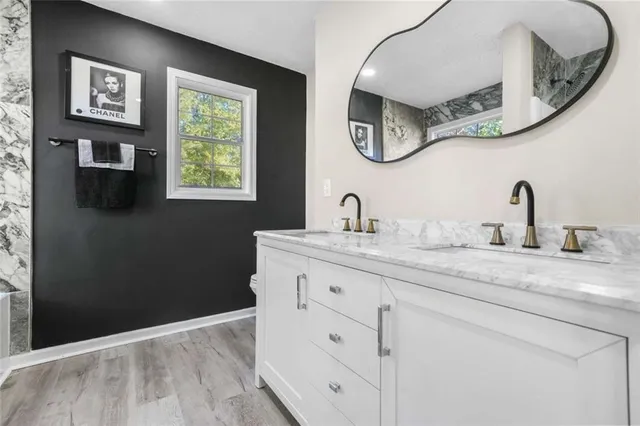 a bathroom with a double vanity sink and a mirror