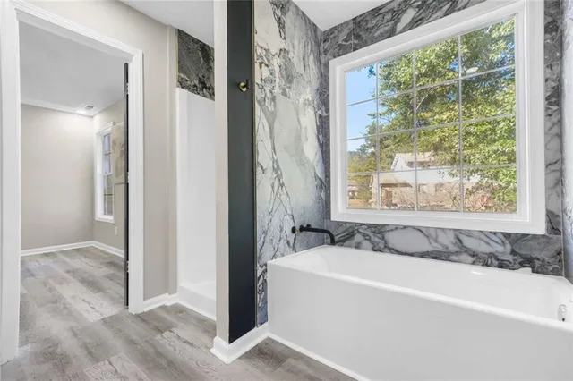 a bathroom with a bathtub and a shower