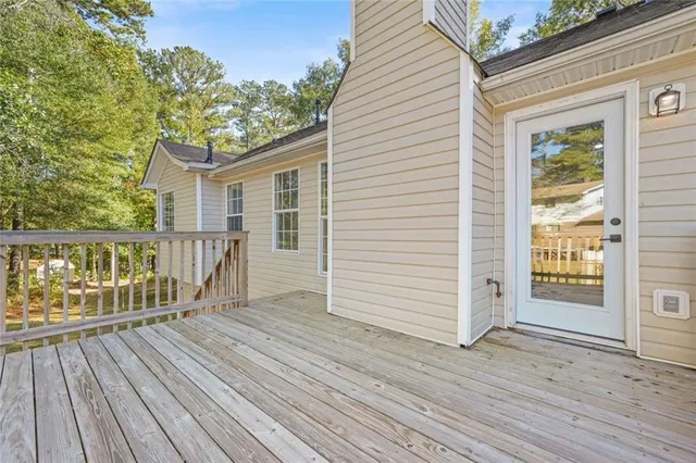 a view of a house with wooden deck