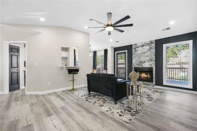 a living room with furniture and a wooden floor