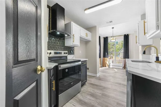 a kitchen with stainless steel appliances granite countertop a stove and a refrigerator