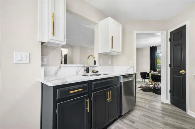 a kitchen with stainless steel appliances granite countertop a sink stove and cabinets
