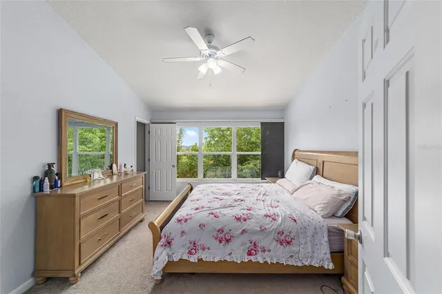 a bedroom with a bed and a large window