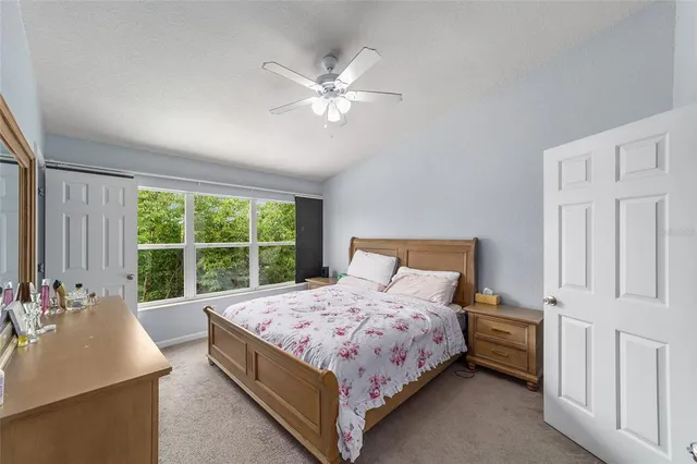 a bedroom with a large bed and a chandelier