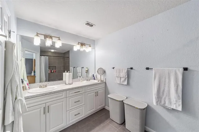 a bathroom with a double vanity sink and mirror