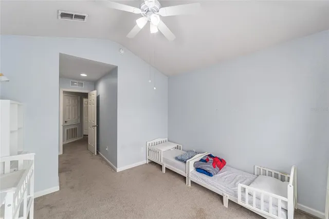 a very nice looking room with a white bed and a chandelier