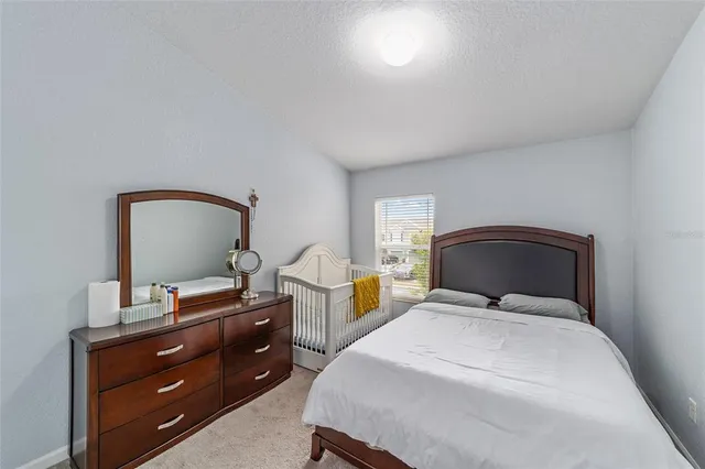 a bedroom with a bed and a dresser