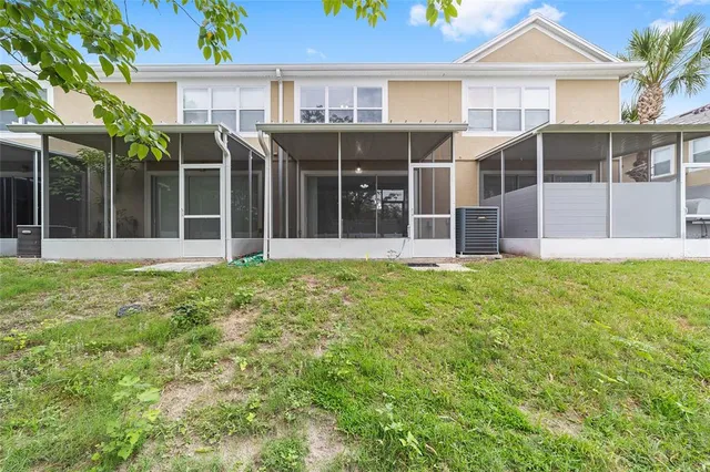 a front view of a house with a yard and glass windows