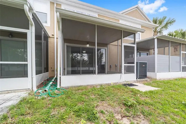 a view of house with yard and glass windows