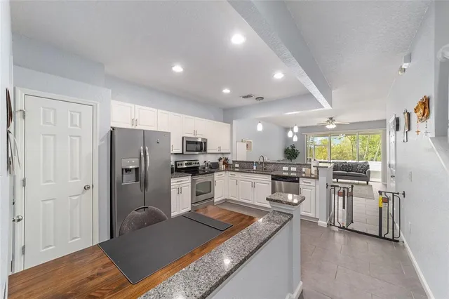 a kitchen with refrigerator and cabinets