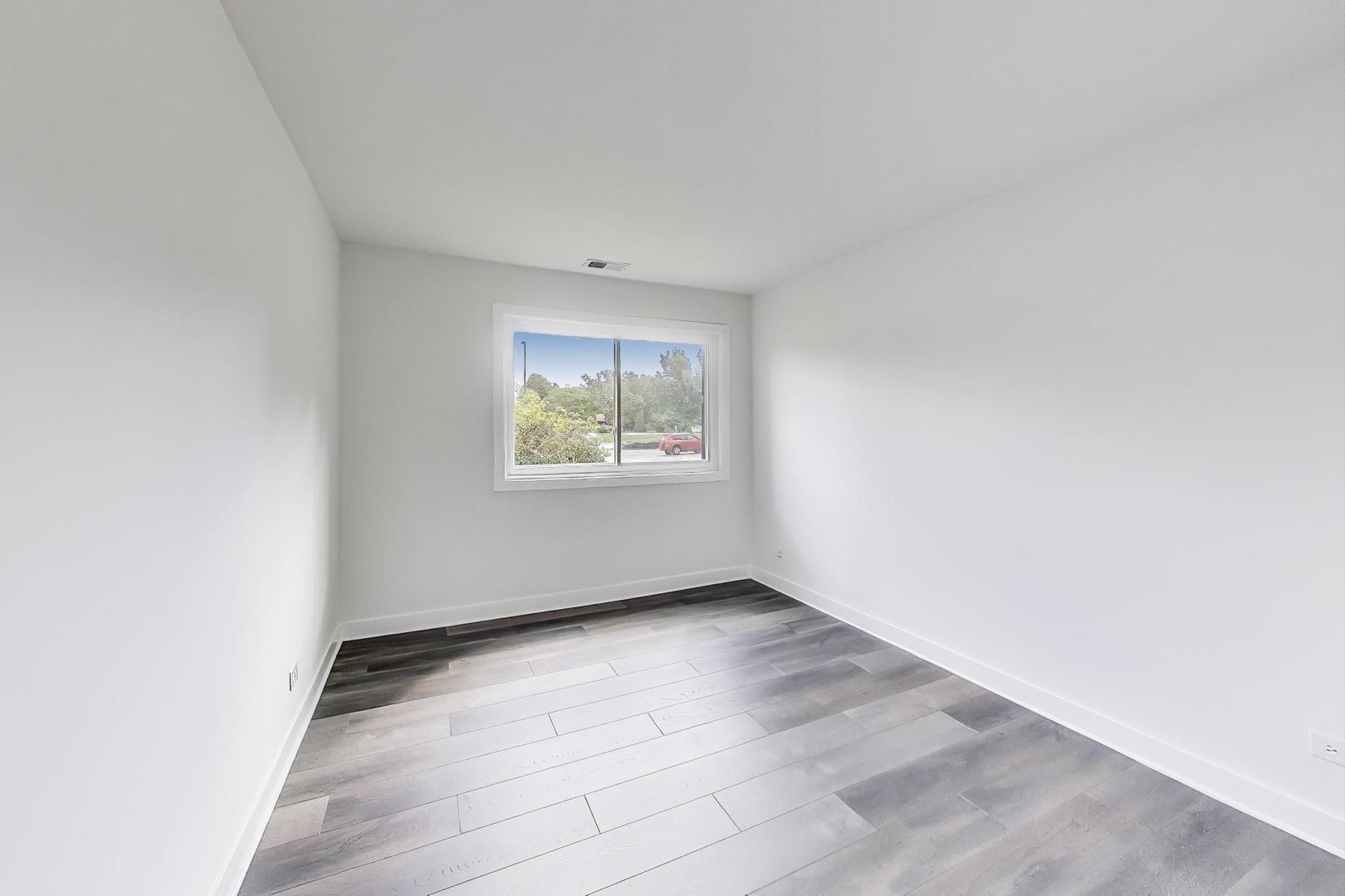 1400 North Elmhurst Road, Unit 106 Mount Prospect, IL 60056 - Photo 13 of 15 an empty room with windows