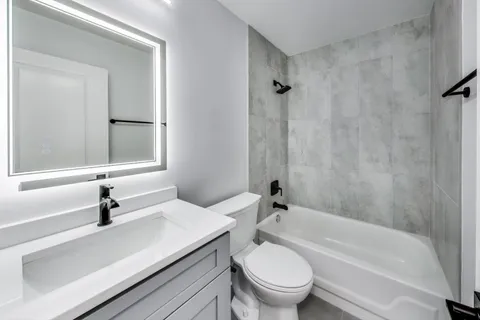 a bathroom with a sink a toilet and a bathtub