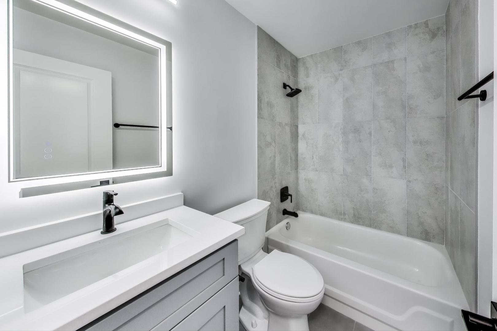 1400 North Elmhurst Road, Unit 106 Mount Prospect, IL 60056 - Photo 15 of 15 a bathroom with a sink a toilet and a bathtub