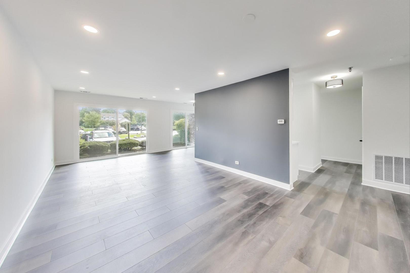 1400 North Elmhurst Road, Unit 106 Mount Prospect, IL 60056 - Photo 3 of 15 a view of an empty room with wooden floor