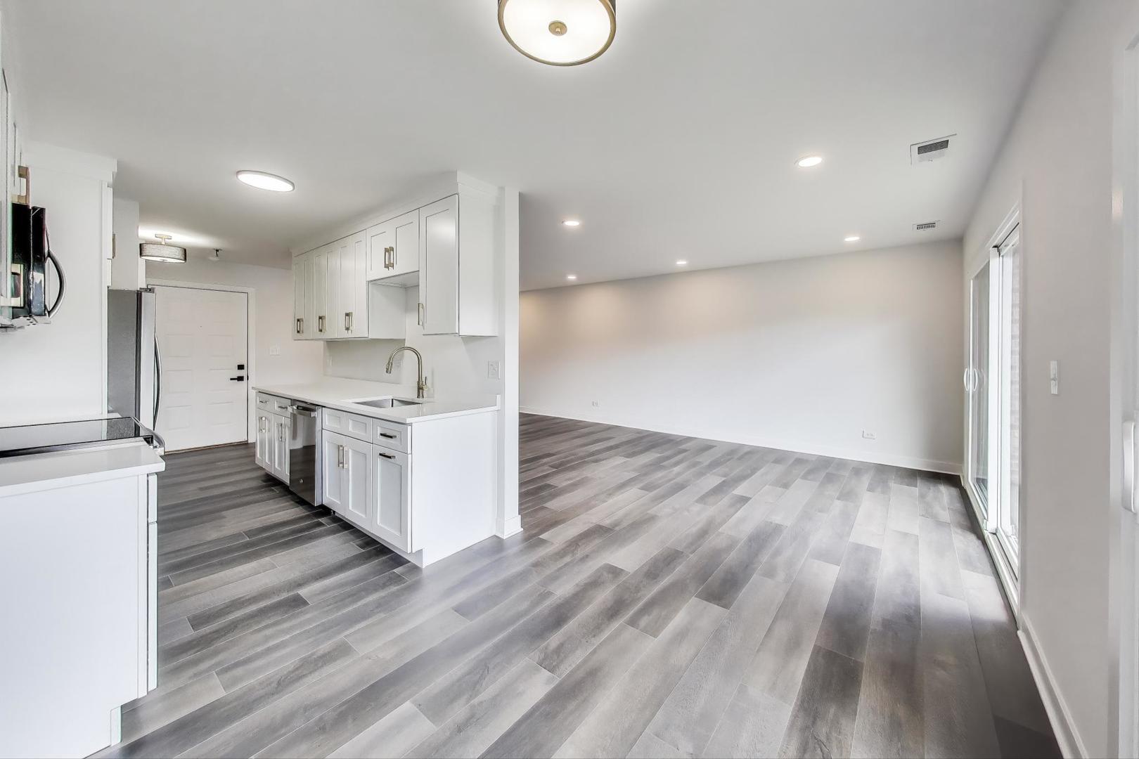 1400 North Elmhurst Road, Unit 106 Mount Prospect, IL 60056 - Photo 6 of 15 a large kitchen with a lot of counter space and wooden floor