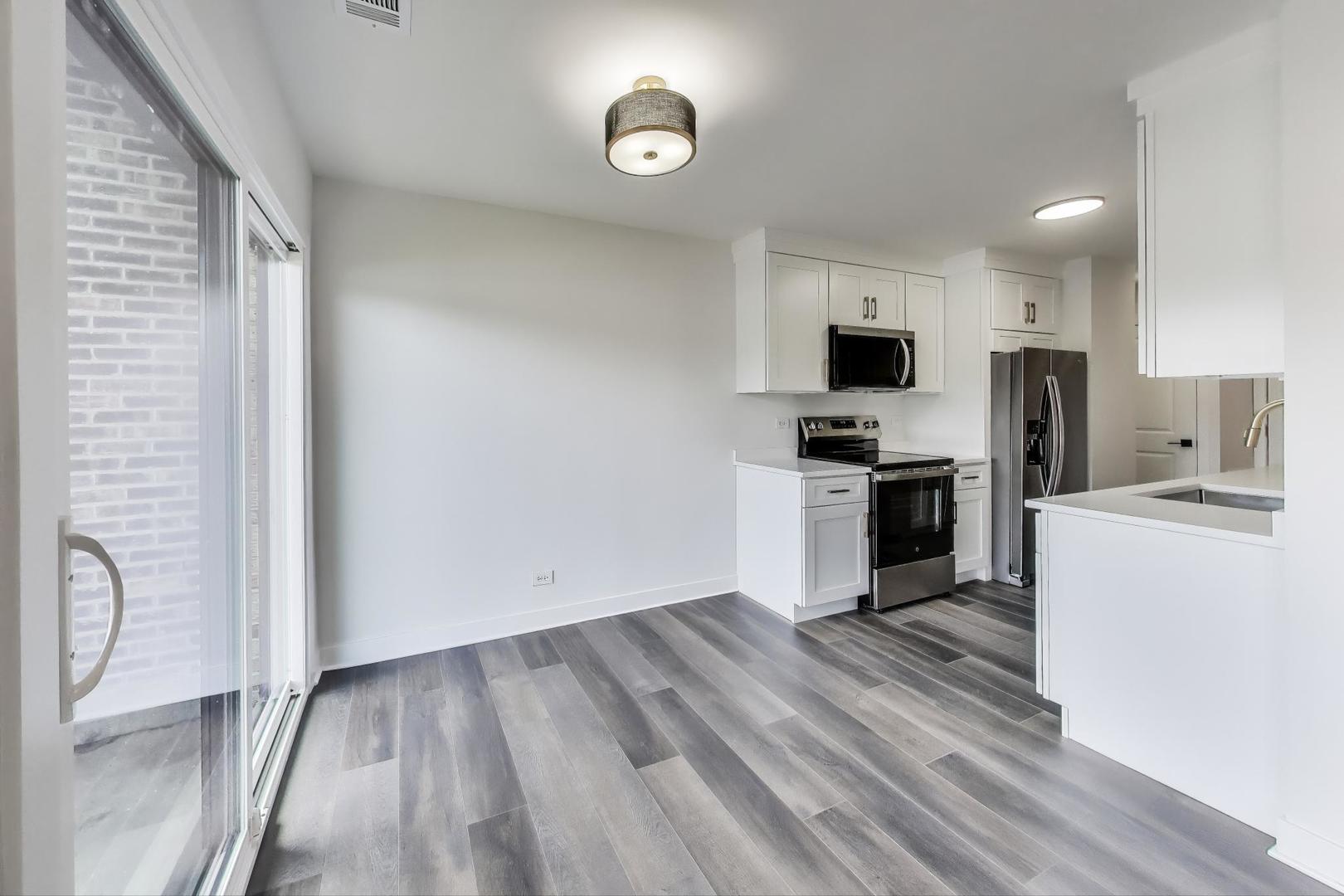 1400 North Elmhurst Road, Unit 106 Mount Prospect, IL 60056 - Photo 7 of 15 a kitchen with a refrigerator and a stove top oven