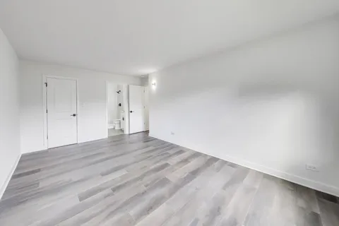 a view of an empty room and wooden floor