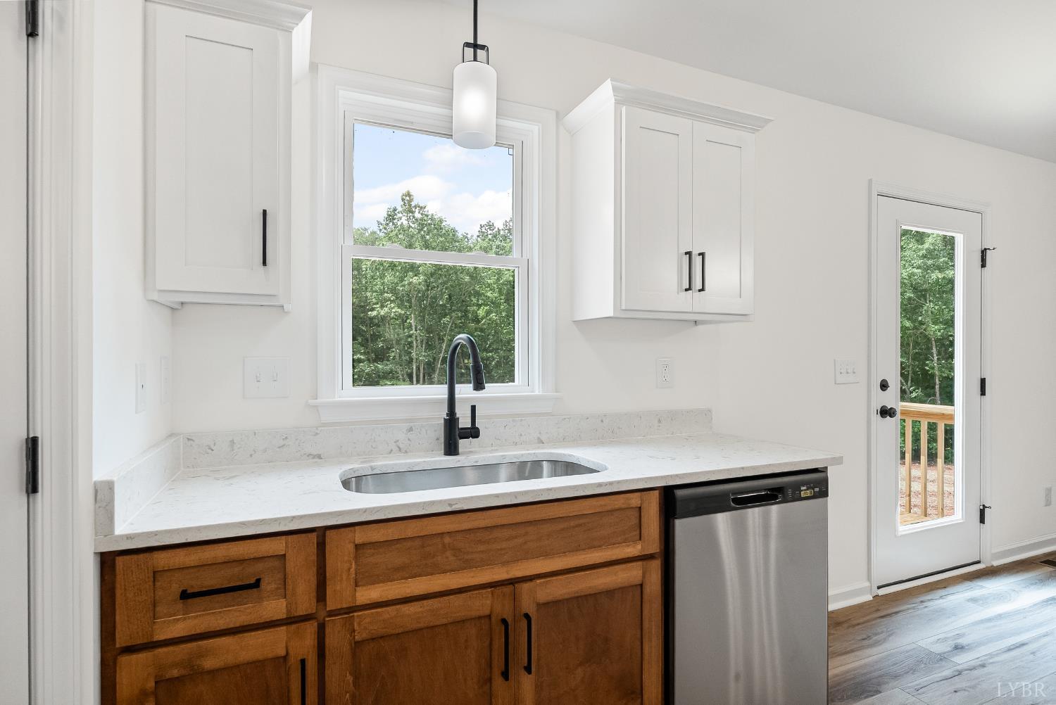 2541 Mitchell Mill Road Gladys, VA 24554 - Photo 11 of 44 a kitchen with stainless steel appliances granite countertop a sink a window and white cabinets with wooden floor