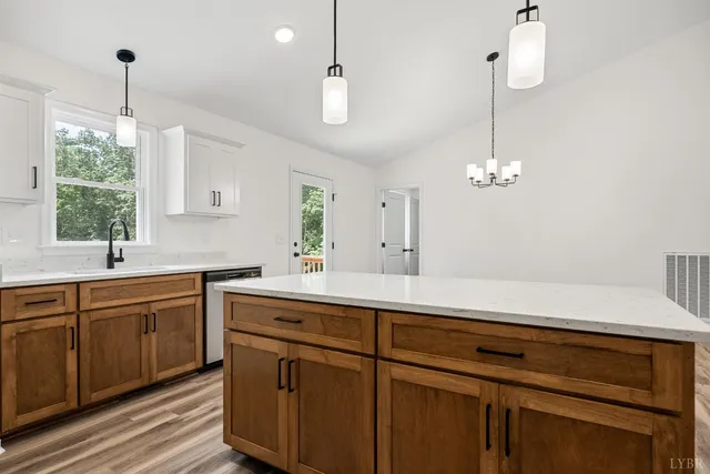 a kitchen with a sink chandelier and stove