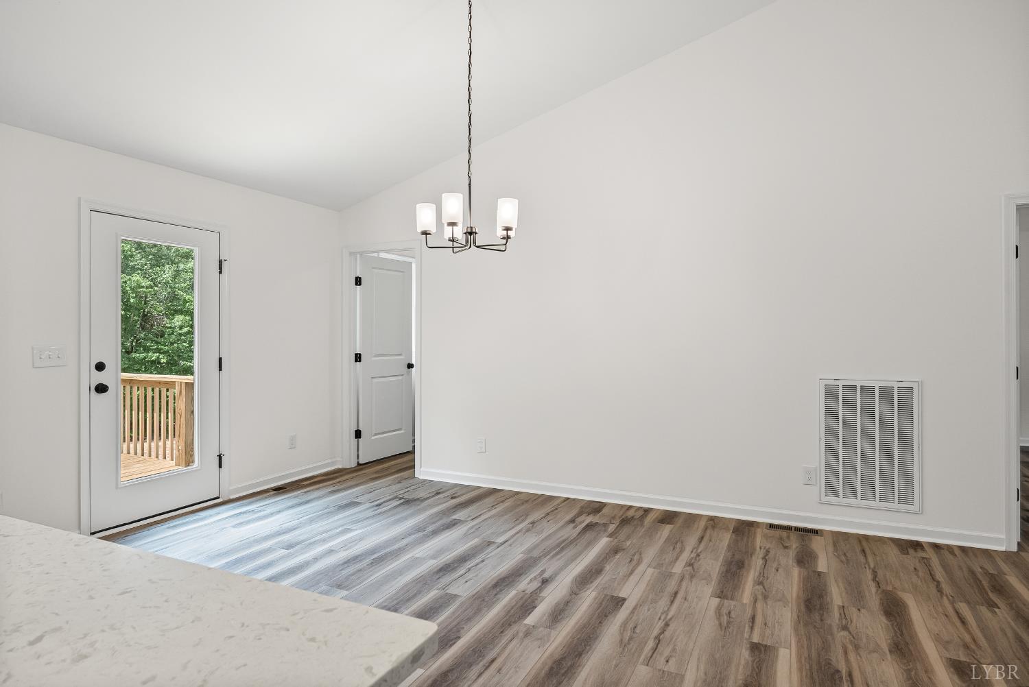 2541 Mitchell Mill Road Gladys, VA 24554 - Photo 15 of 44 a view of an empty room with wooden floor and a window
