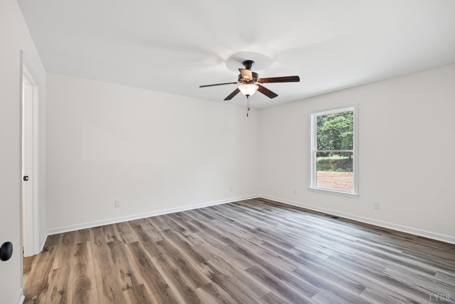 2541 Mitchell Mill Road Gladys, VA 24554 - Photo 18 of 44 a view of empty room with wooden floor and fan
