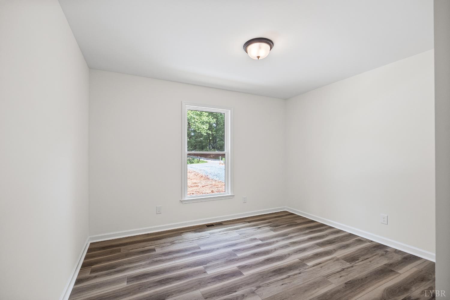 2541 Mitchell Mill Road Gladys, VA 24554 - Photo 24 of 44 an empty room with wooden floor and windows
