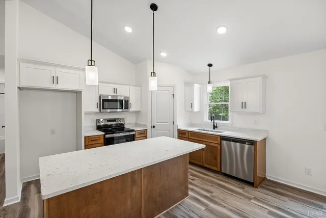 a kitchen with stainless steel appliances a sink stove and refrigerator