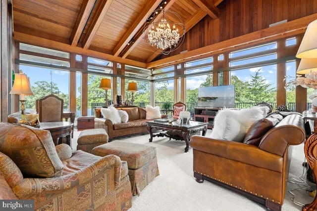 a living room with furniture and a floor to ceiling window