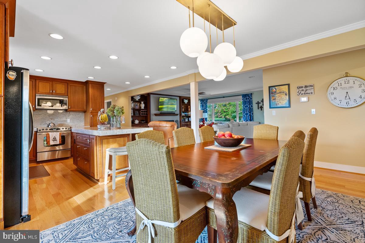27772 Sharp Road Easton, MD 21601 - Photo 70 of 86 a view of a dining room with furniture a chandelier and wooden floor