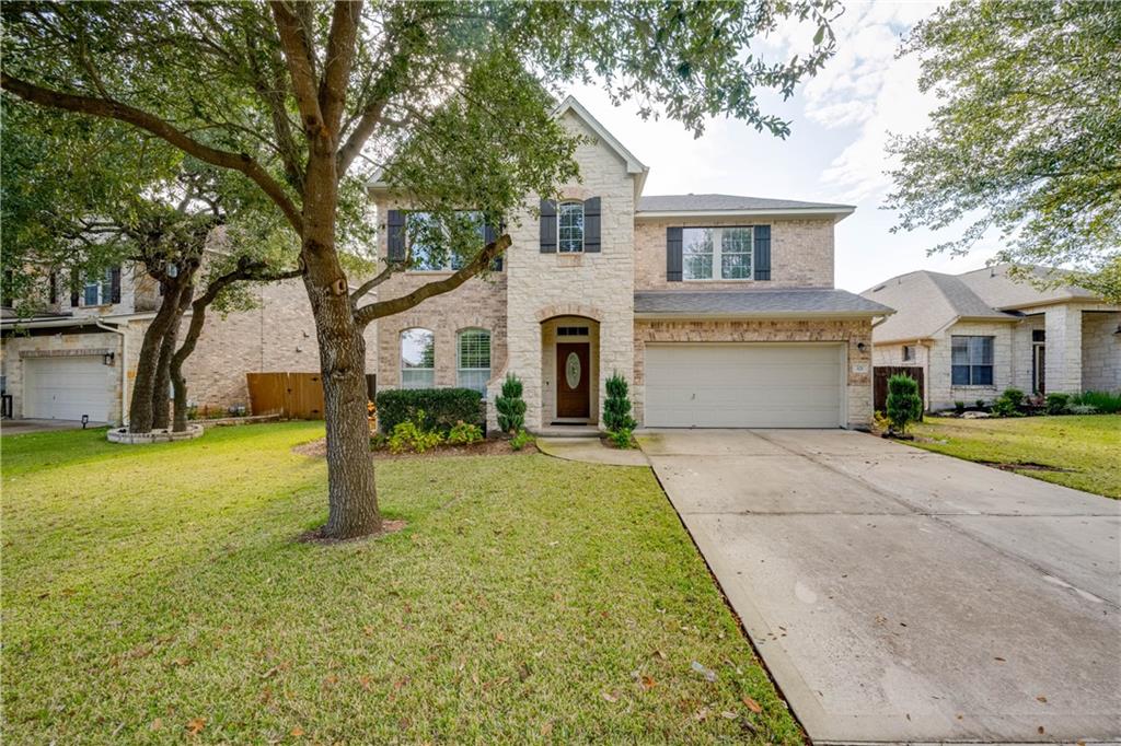 a front view of a house with a yard and garage