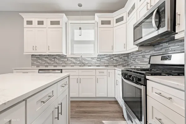 a kitchen with cabinets appliances and a sink