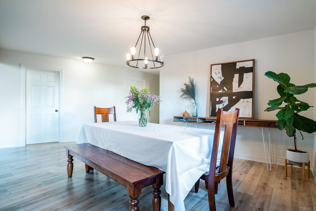 3342 White Hawk Road Escondido, CA 92027 - Photo 16 of 63 a view of a dining room with furniture wooden floor and chandelier